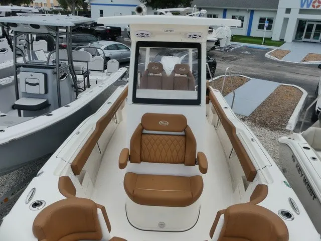 Slide: The Image of The image shows a 2026 Key West 249 FS boat with brown seating and a modern design. - 14