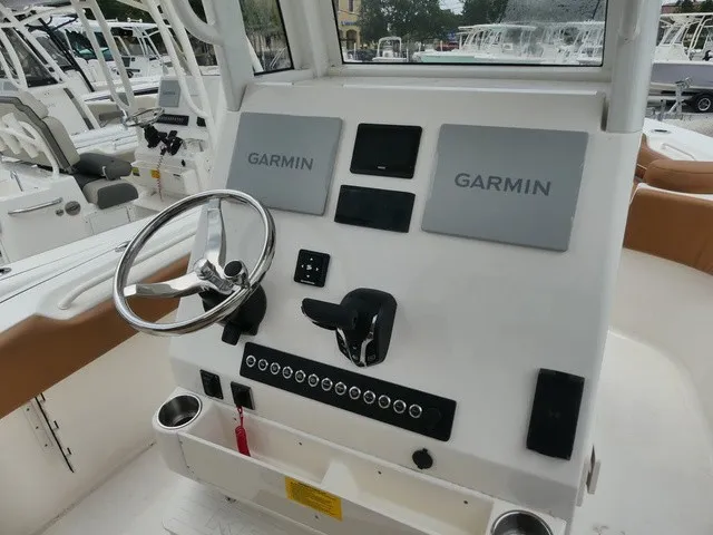 Slide: The Image of The image shows the helm of a Key West 249 FS boat with Garmin electronics. - 8