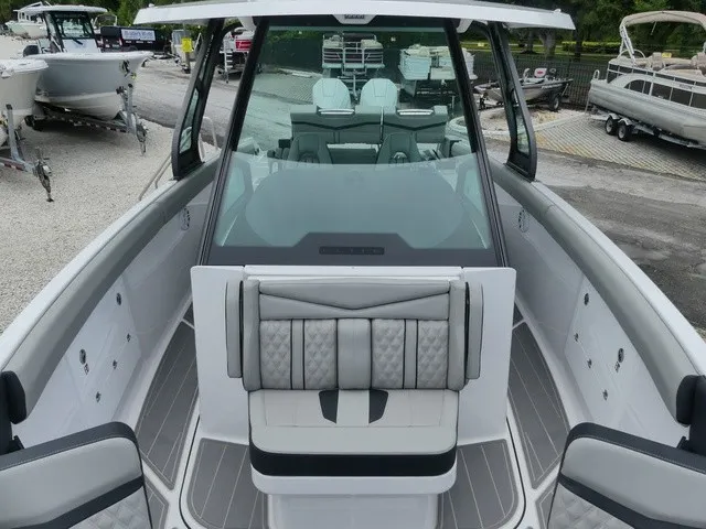 Slide: The Image of The image shows the cockpit of a 2027 Monterey Elite 30 OB boat with sleek seating. - 18