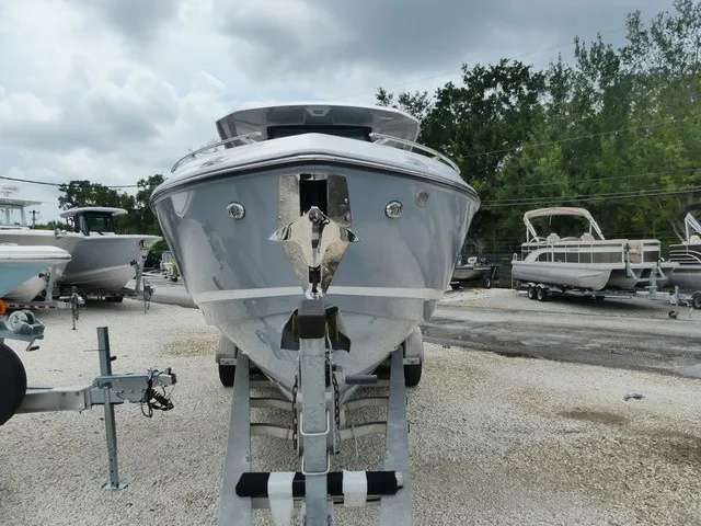 Slide: The Image of A 2027 Monterey Elite 30 OB boat is on a trailer in a gravel lot. - 3