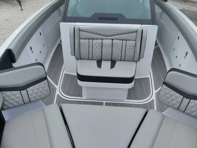 Slide: The Image of The image shows the interior of a 2027 Monterey Elite 30 OB boat with gray upholstery. - 17