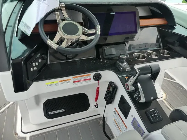 Slide: The Image of The image shows the cockpit of a Monterey Elite 30 OB boat with a modern helm. - 12