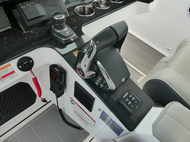 Slide: The Image of The image shows the cockpit of a Monterey Elite 30 OB boat with modern controls and instruments. - 13