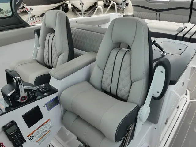 Slide: The Image of Two luxurious, padded seats in a modern boat cockpit with a control console and instruments. - 14