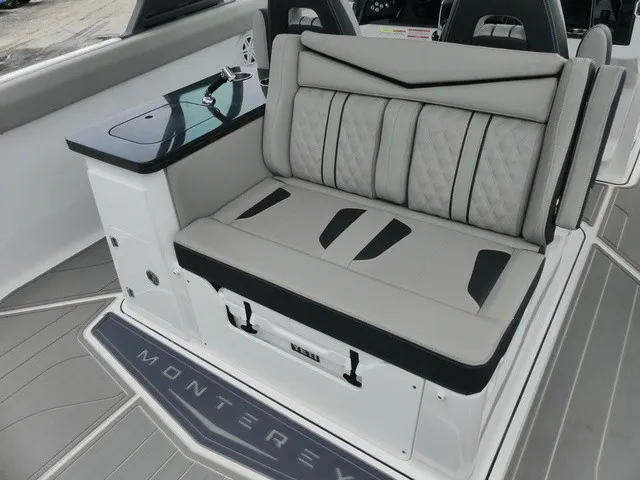 Slide: The Image of The 2027 Monterey Elite 30 OB features a stylish bench seat with gray upholstery and black accents. - 9