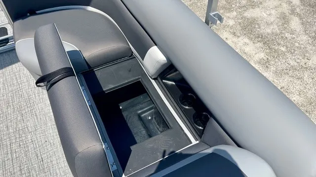 Slide: The Image of The image shows a gray seating area on a boat with an open storage compartment. - 15