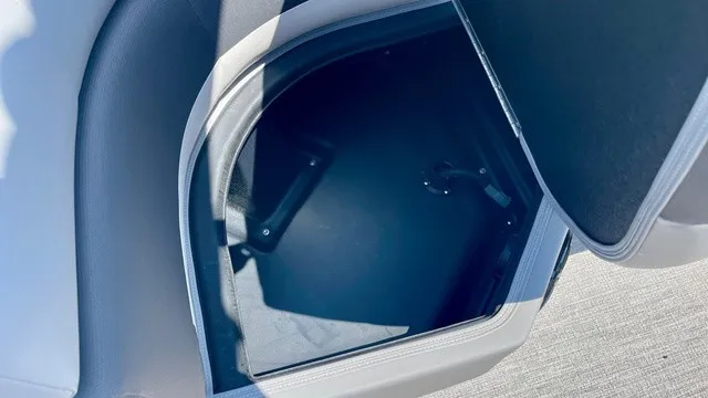 Slide: The Image of An open storage compartment on a boat with cushioned seating and a gray floor. - 14