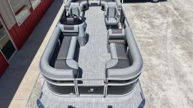 Slide: The Image of The image shows a pontoon boat with gray upholstery and an open deck layout, docked at a pier. - 11