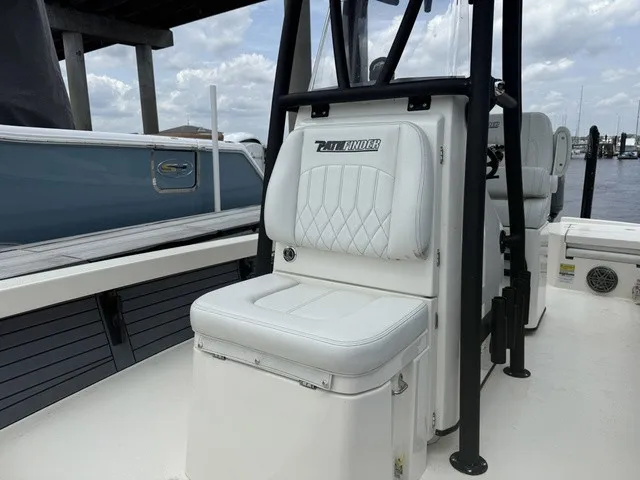 Slide: The Image of Pathfinder 2500 Hybrid 2025: White cushioned seat with quilted pattern, on a boat at the dock. - 12