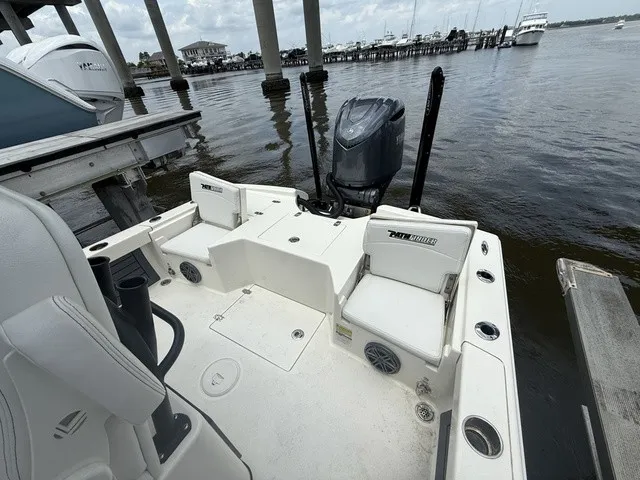 Slide: The Image of The image shows the stern of a 2025 Pathfinder 2500 Hybrid boat docked by the water. - 9