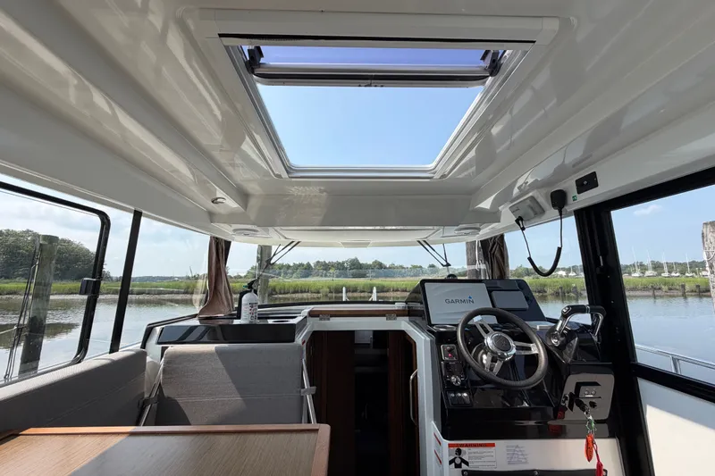 Slide: The Image of Interior view of 2020 Jeanneau NC Sport 895 boat with steering wheel and navigation system. - 20