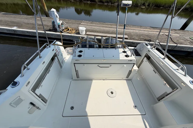 Slide: The Image of 2020 Jeanneau NC Sport 895 boat deck with storage compartments, docked by the water. - 7