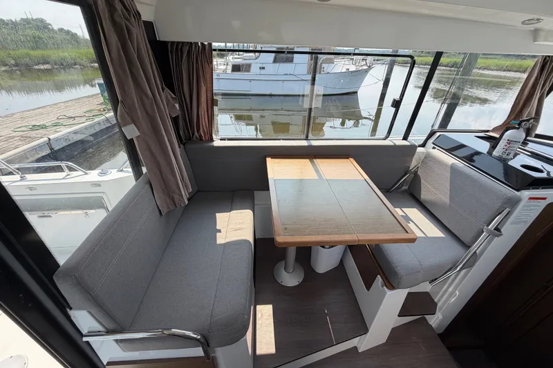 Slide: The Image of Interior of 2020 Jeanneau NC Sport 895 boat with cozy seating and table. - 16