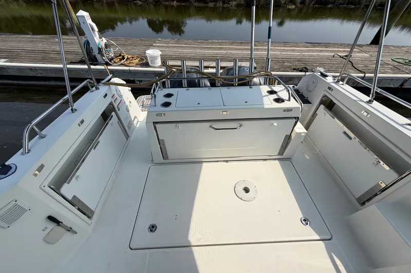 Slide: The Image of 2020 Jeanneau NC Sport 895 boat deck with storage compartments and dock view. - 13
