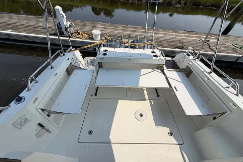 Slide: The Image of 2020 Jeanneau NC Sport 895 boat interior with foldable seating and dock view. - 10