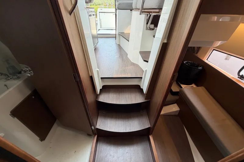 Slide: The Image of Interior view of 2020 Jeanneau NC Sport 895 boat, featuring stairs and seating area. - 36