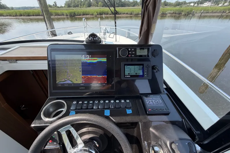 Slide: The Image of Cockpit view of 2020 Jeanneau NC Sport 895 with navigation and control systems. - 23