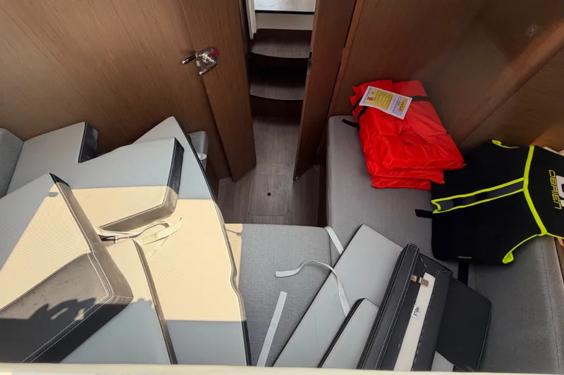 Slide: The Image of Interior of 2020 Jeanneau NC Sport 895 with life jackets and cushions. - 53
