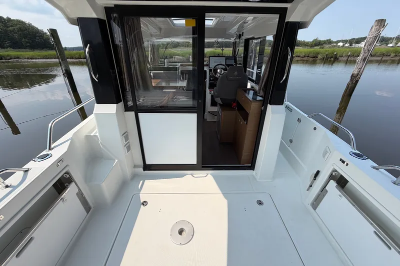 Slide: The Image of 2020 Jeanneau NC Sport 895 boat interior with open cockpit and helm view. - 12
