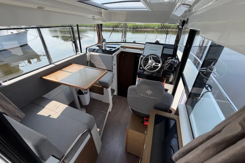 Slide: The Image of Interior of 2020 Jeanneau NC Sport 895 boat with helm, seating, and table. - 14