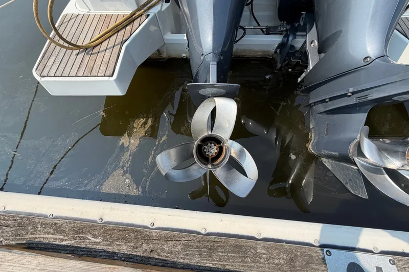 Slide: The Image of Propellers of a 2020 Jeanneau NC Sport 895 boat in water at a dock. - 72
