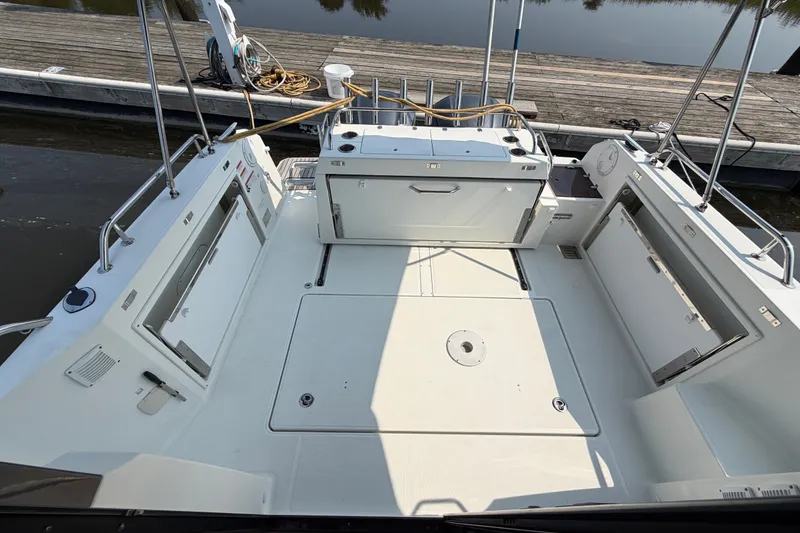 Slide: The Image of 2020 Jeanneau NC Sport 895 boat deck with storage compartments and fishing rod holders. - 9
