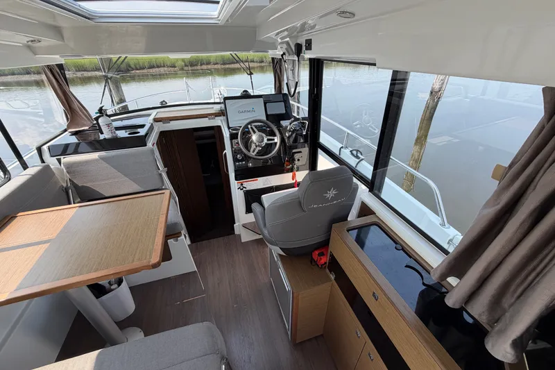 Slide: The Image of Interior of 2020 Jeanneau NC Sport 895 boat with helm, seating, and dining area. - 17