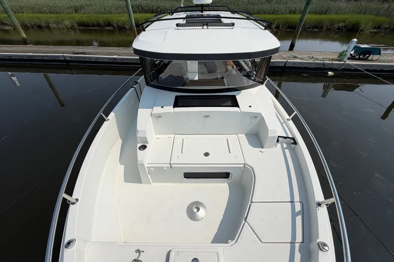 Slide: The Image of 2020 Jeanneau NC Sport 895 boat docked, showcasing spacious deck and sleek design. - 43