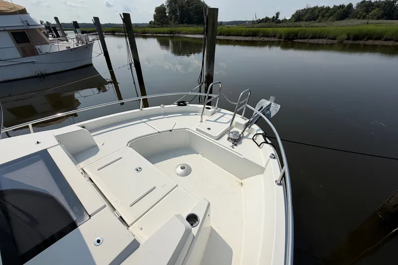 Slide: The Image of 2020 Jeanneau NC Sport 895 boat docked on calm water, showcasing spacious deck. - 41