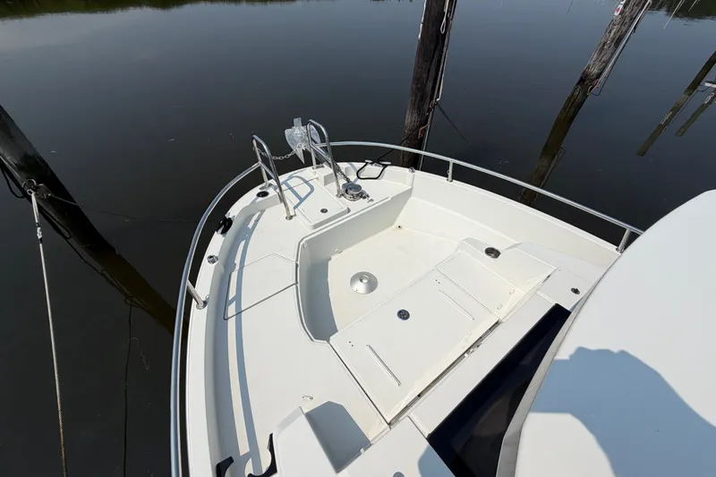 Slide: The Image of 2020 Jeanneau NC Sport 895 boat deck with railing and anchor, docked on calm water. - 45