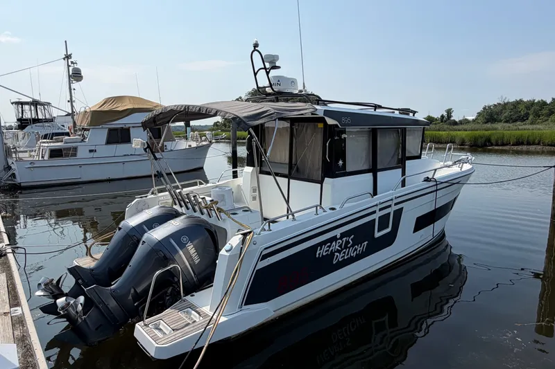Slide: The Image of 2020 Jeanneau NC Sport 895 boat docked with twin Yamaha engines. - 1