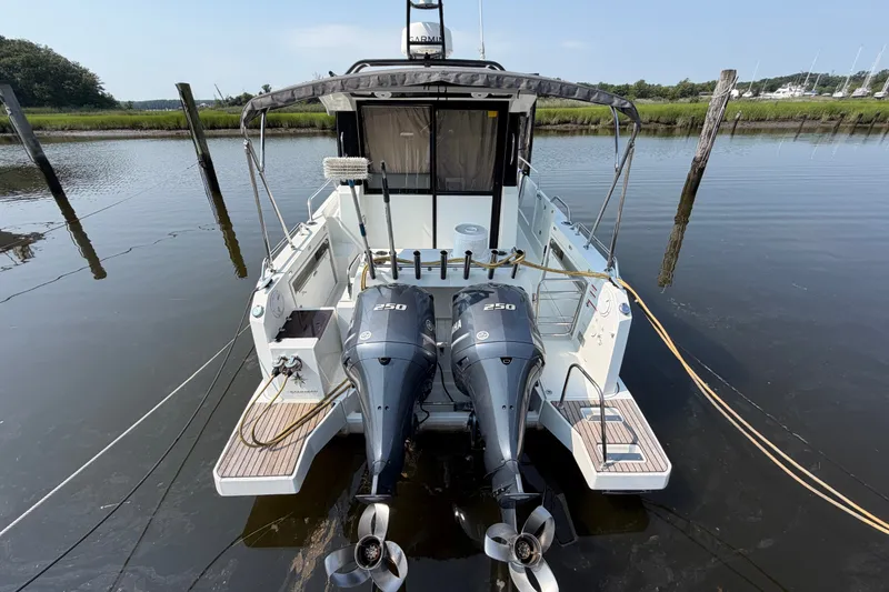 Slide: The Image of 2020 Jeanneau NC Sport 895 with dual Yamaha 250 engines docked on calm water. - 3
