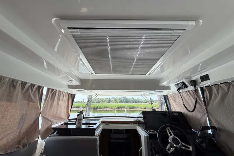 Slide: The Image of Interior view of 2020 Jeanneau NC Sport 895 boat with helm and panoramic windows. - 21