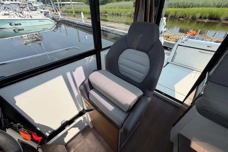 Slide: The Image of Interior of 2020 Jeanneau NC Sport 895 boat with a comfortable captain's chair. - 24