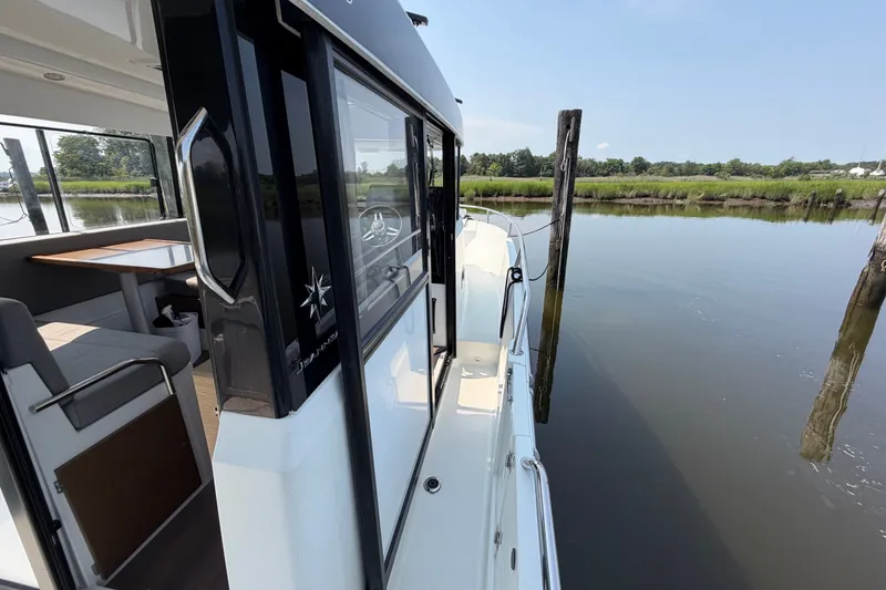 Slide: The Image of 2020 Jeanneau NC Sport 895 docked, showcasing sleek design and spacious interior. - 38