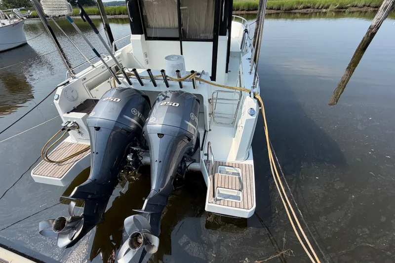 Slide: The Image of 2020 Jeanneau NC Sport 895 with dual Yamaha 250 engines docked on calm water. - 5