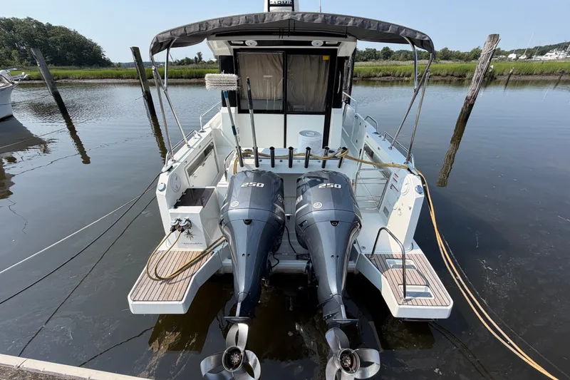 Slide: The Image of 2020 Jeanneau NC Sport 895 boat with dual Yamaha 250 engines docked at marina. - 4