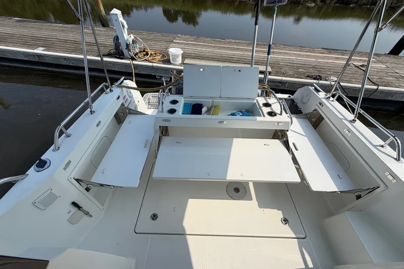 Slide: The Image of 2020 Jeanneau NC Sport 895 boat deck with open storage compartments at dock. - 8