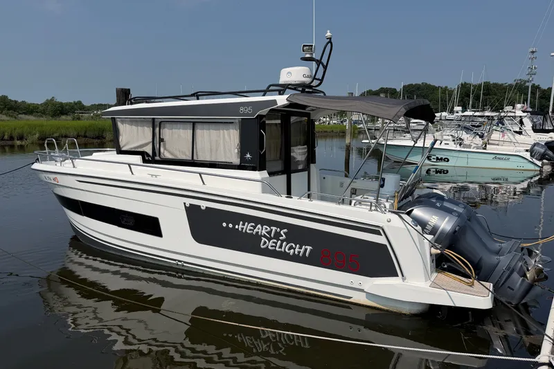 Slide: The Image of 2020 Jeanneau NC Sport 895 boat docked, featuring "Heart's Delight" name and twin Yamaha engines. - 2