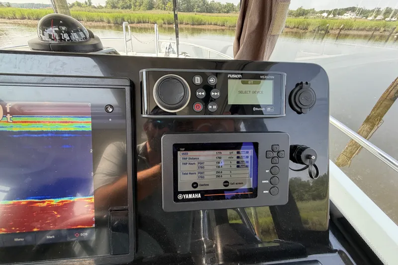 Slide: The Image of Dashboard of a 2020 Jeanneau NC Sport 895 boat with navigation and control systems. - 64