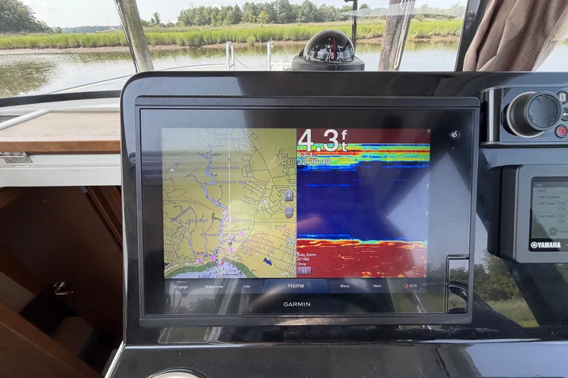 Slide: The Image of Garmin navigation display on 2020 Jeanneau NC Sport 895 boat, showing map and sonar data. - 68