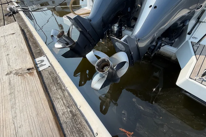 Slide: The Image of Twin outboard motors on a 2020 Jeanneau NC Sport 895 docked at a marina. - 71