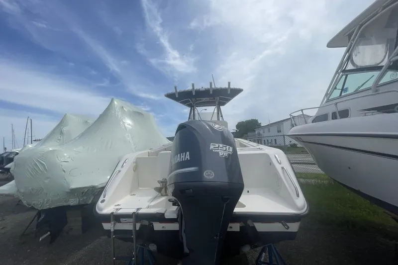 Slide: The Image of 2013 Pursuit C 230 Center Console boat with Yamaha 250 V6 engine, docked outdoors. - 10