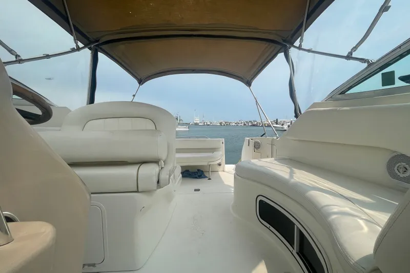 Slide: The Image of Interior view of a 2000 Sea Ray 270 Sundancer boat with beige seating and canopy. - 14