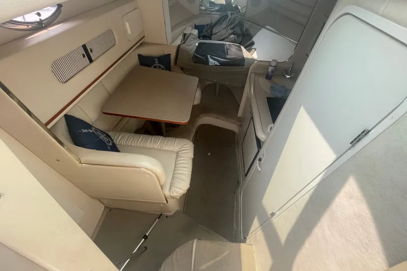 Slide: The Image of Interior of 2000 Sea Ray 270 Sundancer boat with seating and table. - 8