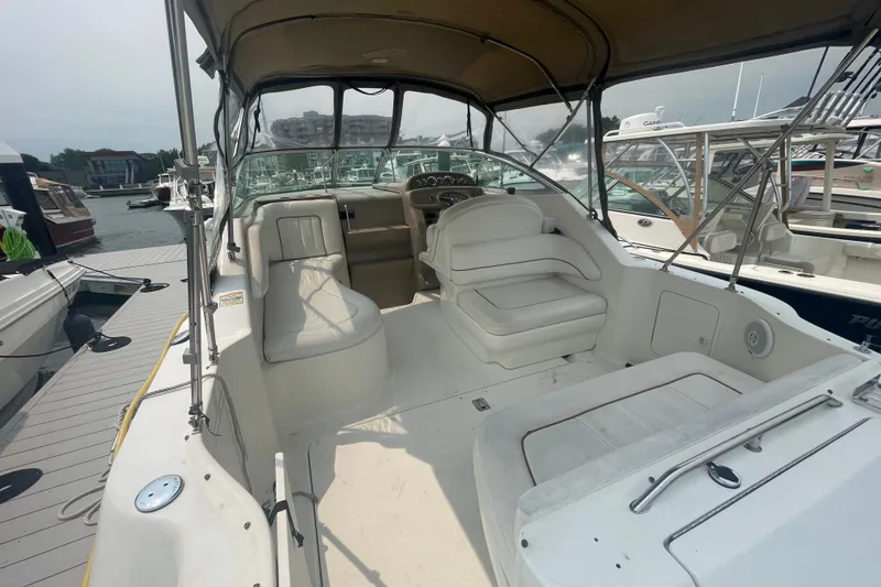 Slide: The Image of 2000 Sea Ray 270 Sundancer boat interior with seating, docked at marina. - 4