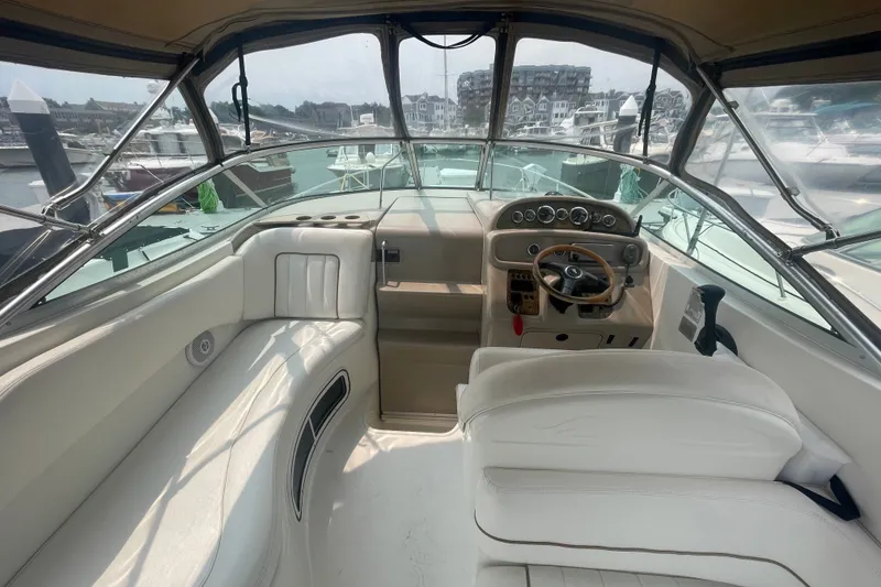 Slide: The Image of Cockpit of 2000 Sea Ray 270 Sundancer with white seating and steering wheel. - 6
