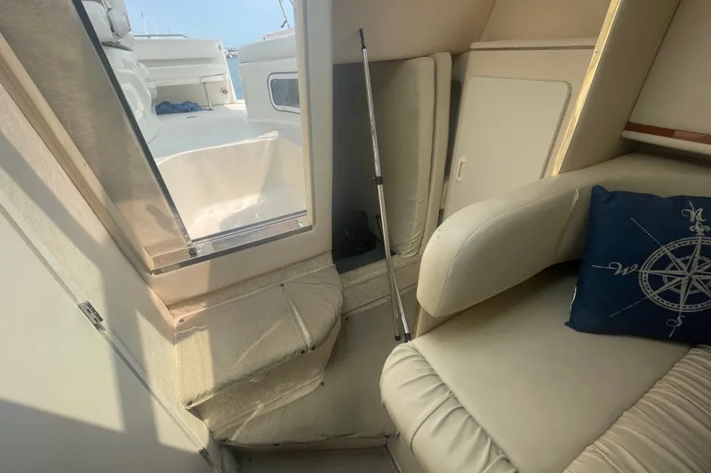 Slide: The Image of Interior view of 2000 Sea Ray 270 Sundancer boat with seating and nautical-themed pillow. - 12
