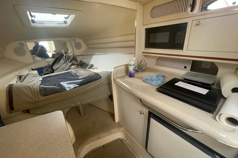 Slide: The Image of Interior of 2000 Sea Ray 270 Sundancer boat with kitchenette and sleeping area. - 10