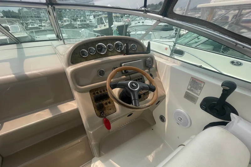 Slide: The Image of Cockpit of 2000 Sea Ray 270 Sundancer with steering wheel and control panel. - 7